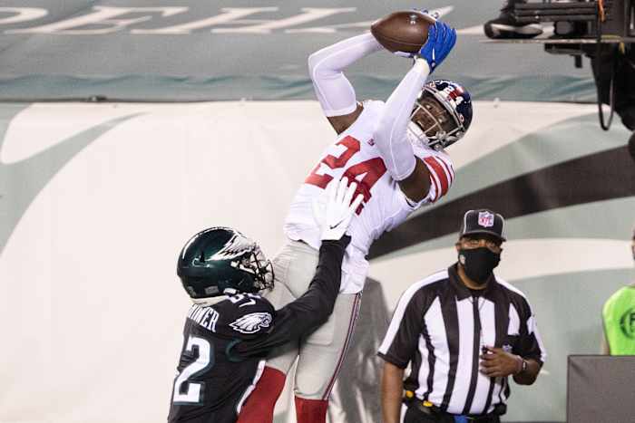 Oct 22, 2020; Philadelphia, Pennsylvania, USA; New York Giants cornerback James Bradberry (24) intercepts the ball in front of Philadelphia Eagles wide receiver John Hightower (82) during the second quarter at Lincoln Financial Field.